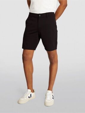 Paige brand black shorts featuring a prominent button closure.